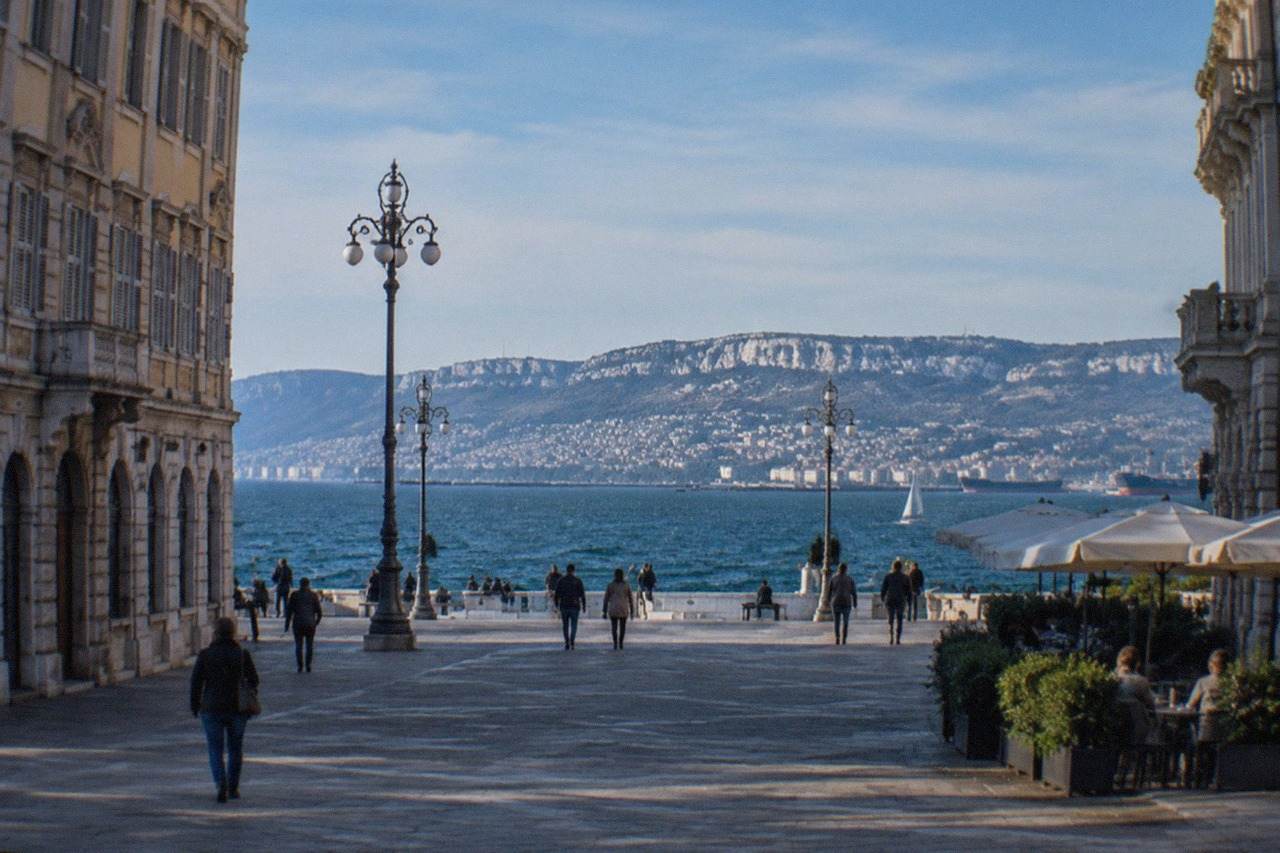 The seafront square of Trieste with the Adriatic gulf behind it on a bright morning