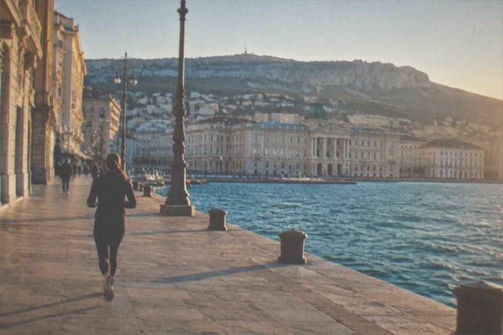 Evening light on the seafront of Trieste, Italy, with the city's grand waterfront buildings along the Adriatic