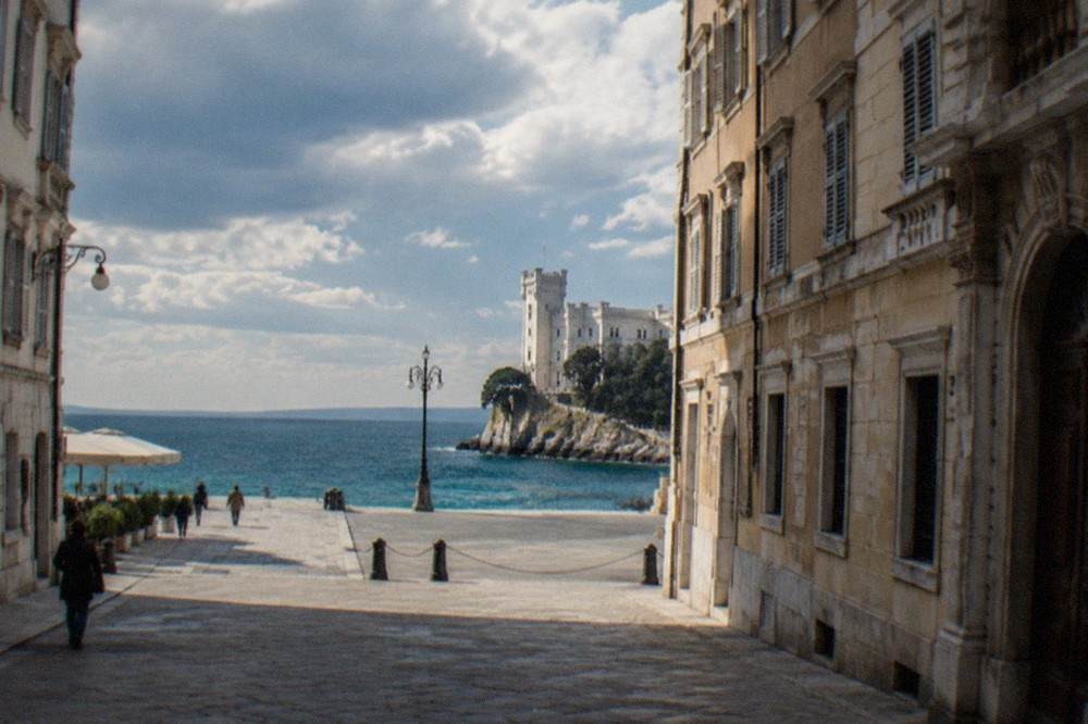 A white castle above the sea on a rocky coastline north of Trieste, Italy