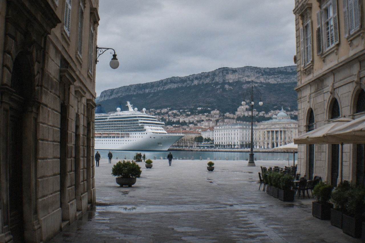 Cruise ship docked at the Trieste cruise terminal with the city waterfront in the background