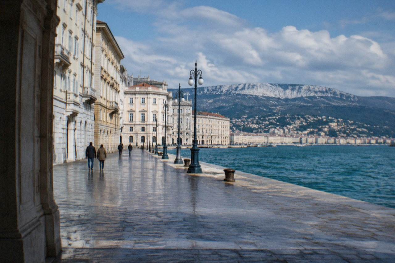 The seafront square of Trieste with the sea reaching the paving and historic facades along one side