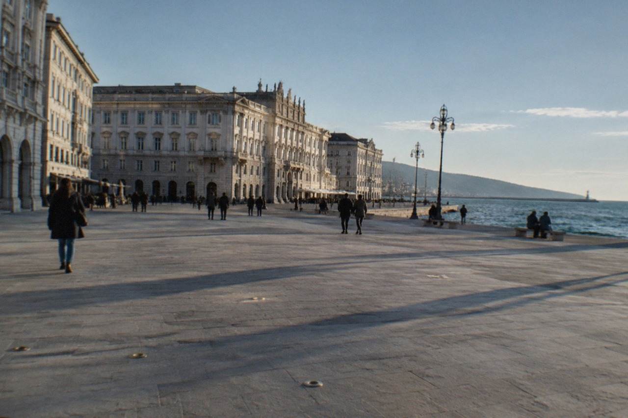 The seafront of Trieste with the Piazza Unità d'Italia buildings facing the water on a calm afternoon