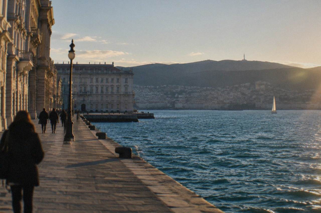 The seafront of Trieste, Italy, with the Gulf of Trieste and distant hills across the water.