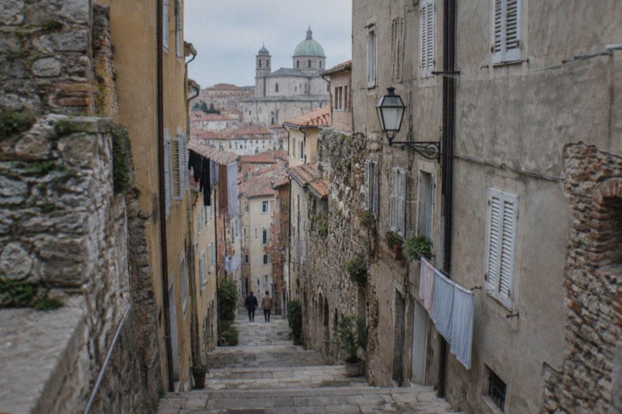 Narrow stepped lane in Trieste's old town rising toward the cathedral hill