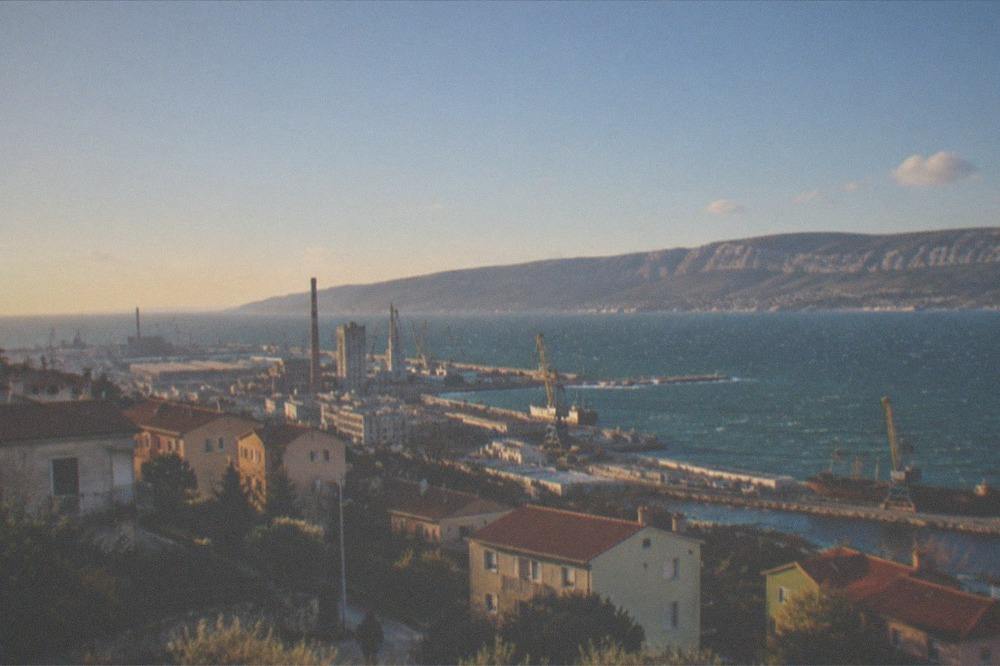 White-capped water in Muggia Bay under a clear windy sky