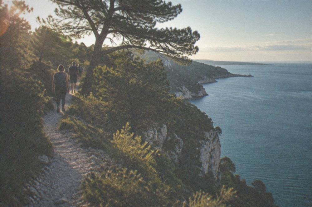 Walkers on the Rilke Trail cliff path above the Adriatic near Duino