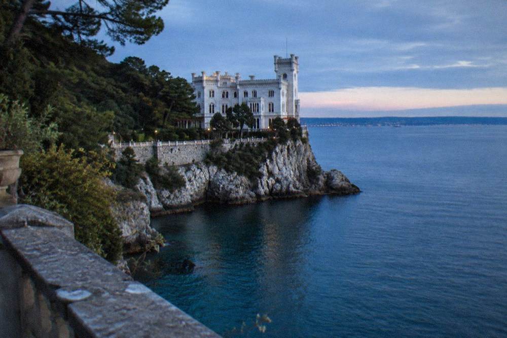 A stone viewpoint in the Miramare park looking out over the blue water of the Gulf of Trieste