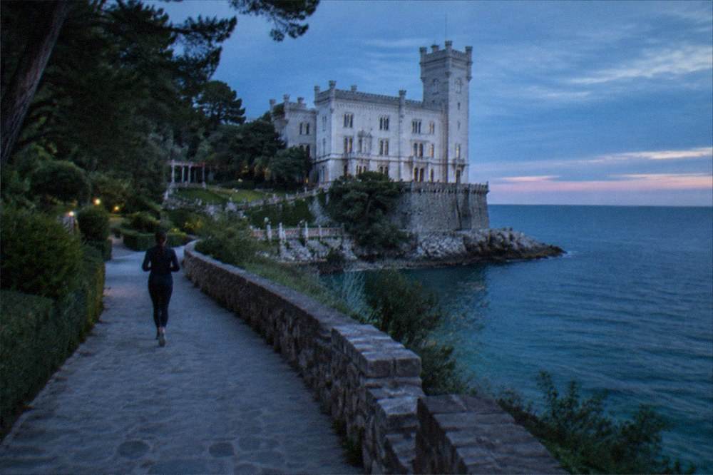 Miramare Castle seen from its park with the sea behind it