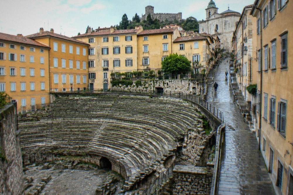 Steep old town lane in Trieste climbing from the Roman theatre toward the cathedral and castle on the hill