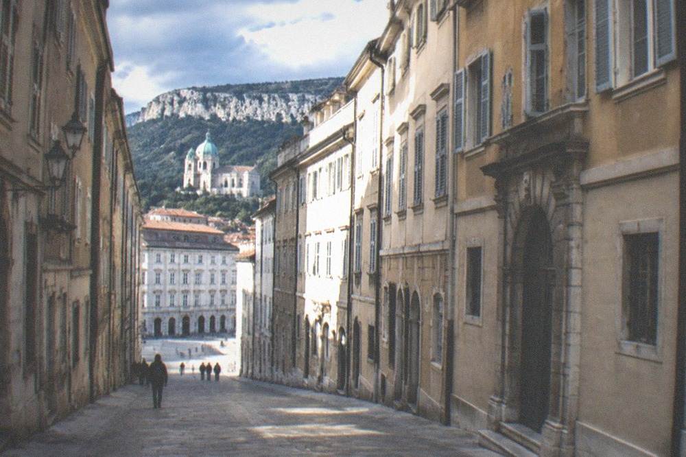 Steep old town street in Trieste leading up toward the cathedral hill