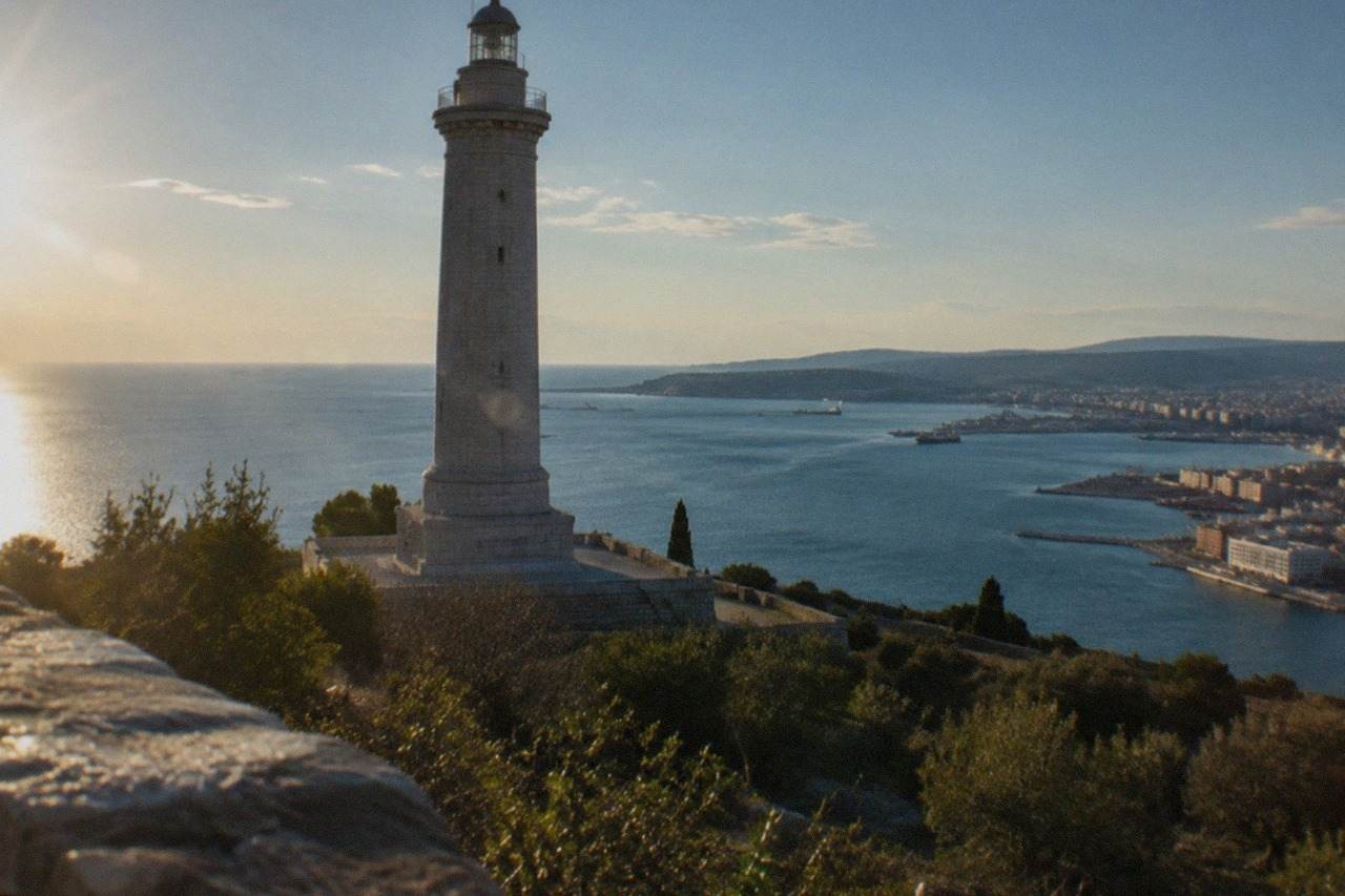 The Victory Lighthouse standing on the Trieste seafront with the Adriatic Gulf behind it