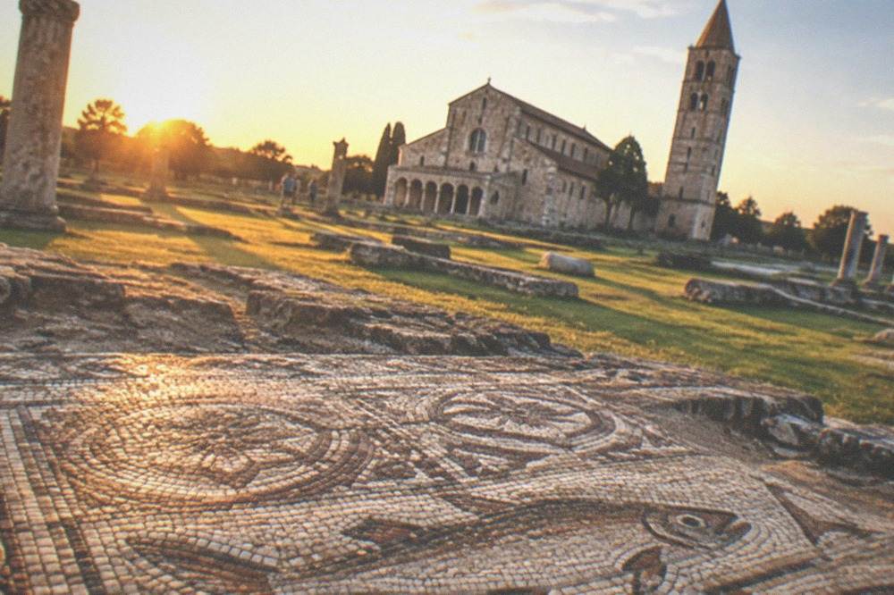 Mosaic floor detail showing ancient fish and geometric patterns in earth colours