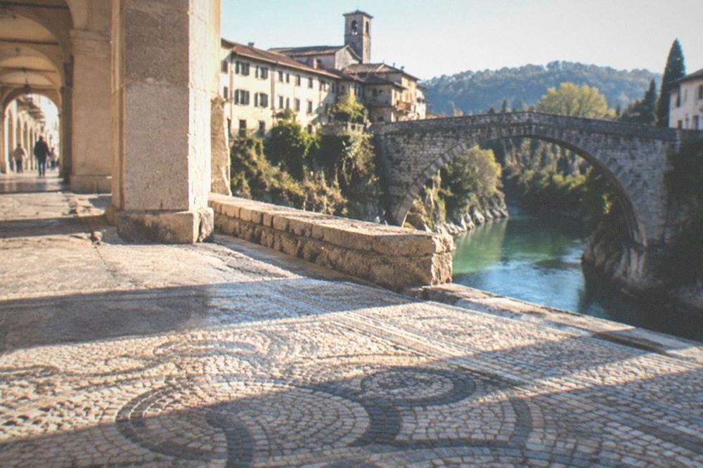 An ancient stone floor with mosaic patterns inside an Italian archaeological site