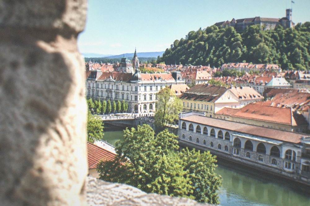 Ljubljana's old town rooftops seen from the castle hill on a bright day
