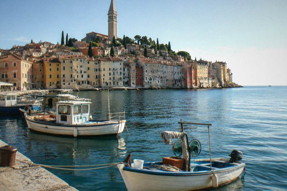 Fishing boats moored along the Rovinj waterfront in the morning