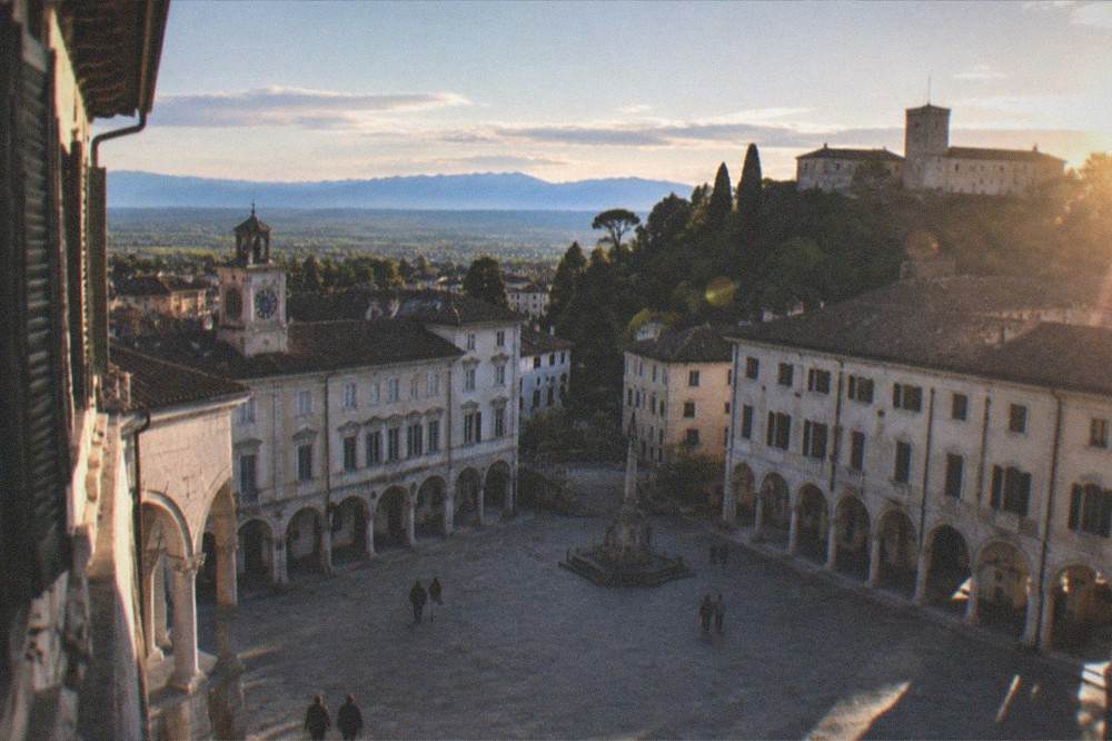 Panorama of the Friulian plain with hills and distant mountains under a wide sky
