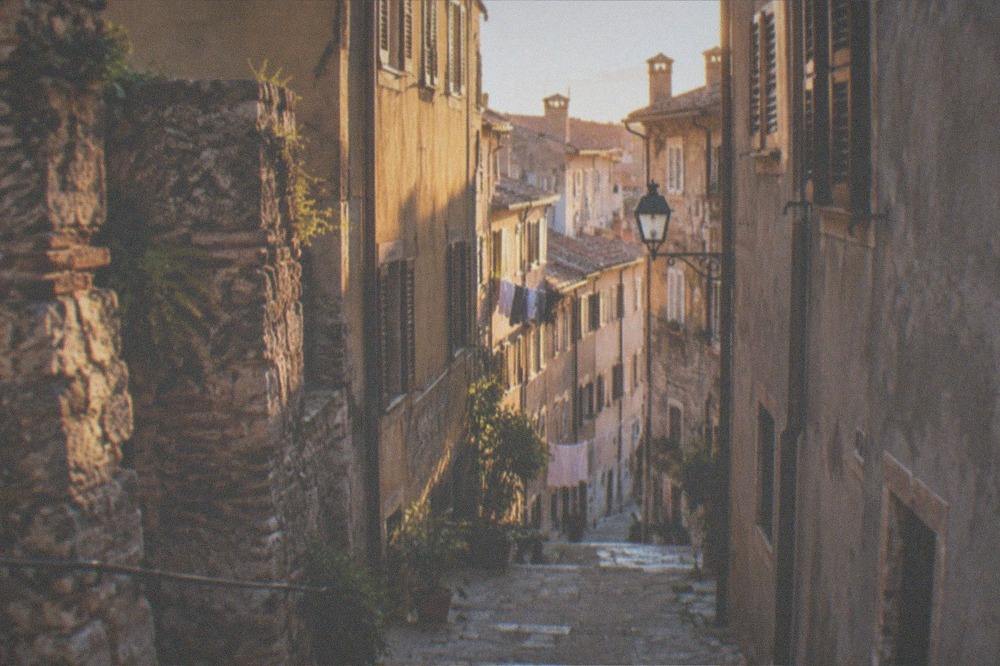 A narrow street in the Città Vecchia old town of Trieste with old stone buildings