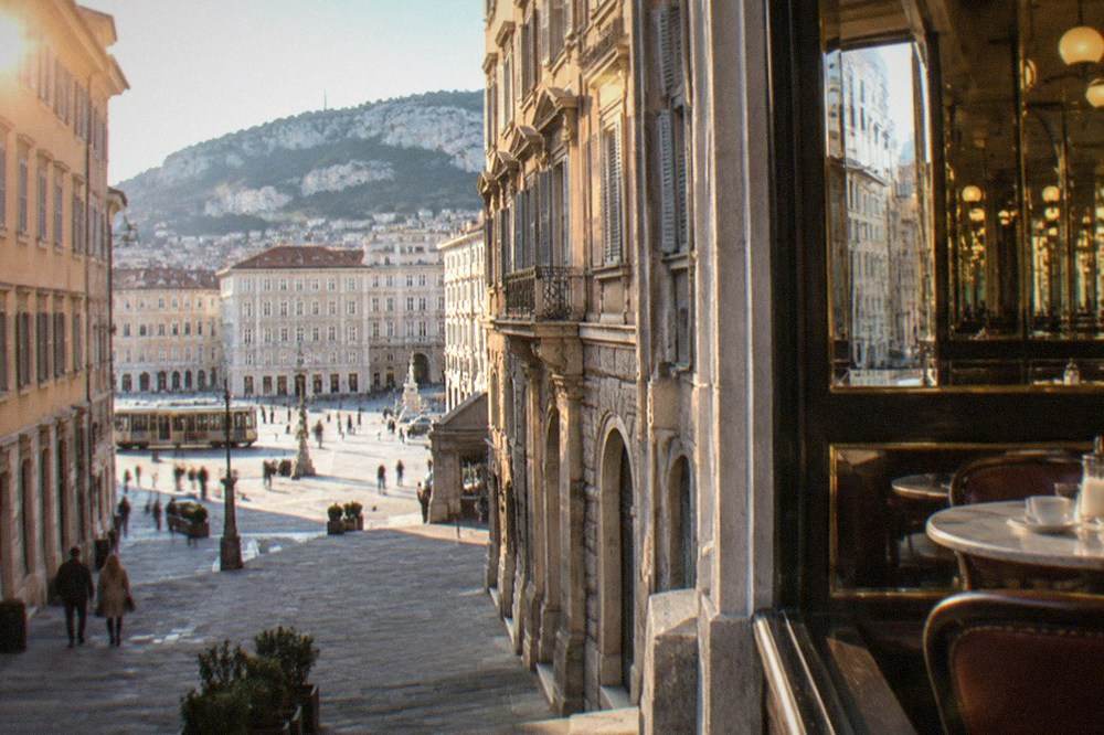 The interior of a historic Trieste caffè with marble tables and mirrored walls
