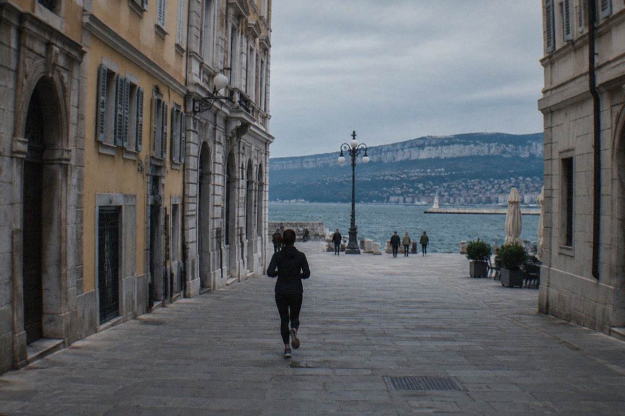 The seafront of Trieste, Italy, on a calm morning with the waterfront square and distant hills