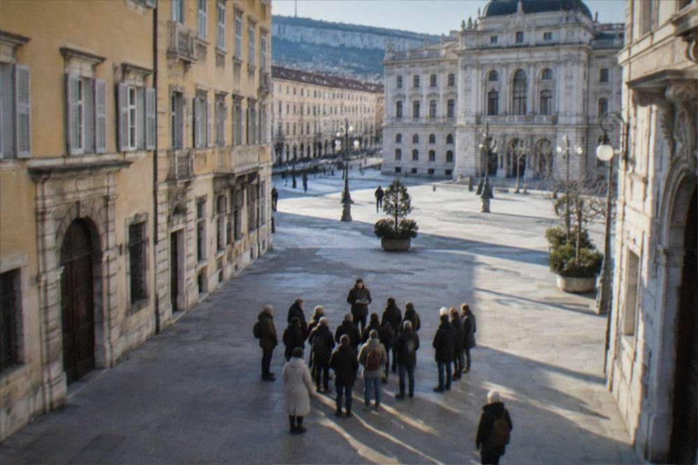 A guided walking group in a Trieste square with an ornate building behind them