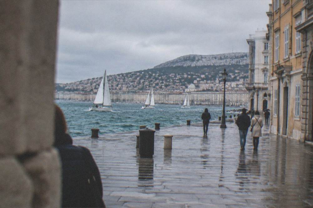 Sailing boats on the Gulf of Trieste in October with the city waterfront in the background