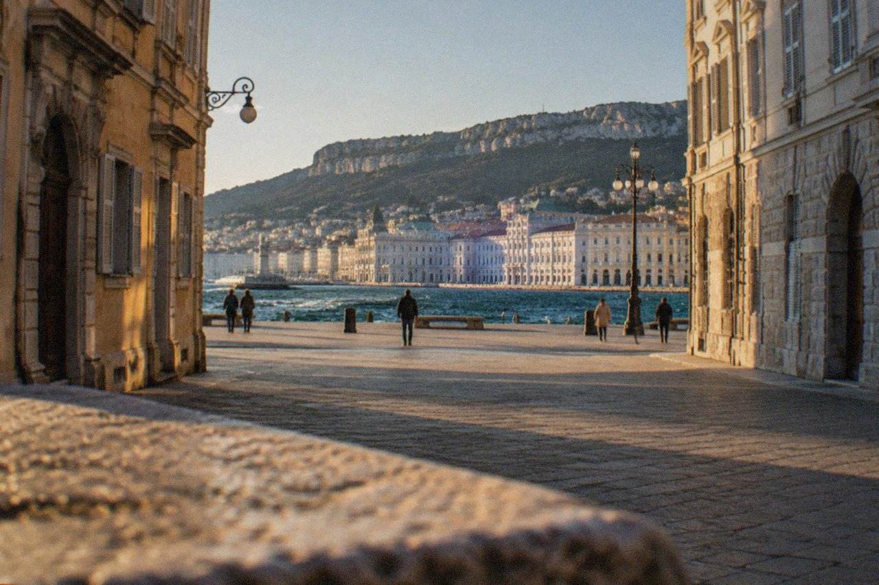 The seafront museum buildings of Trieste seen across the wide square on the water