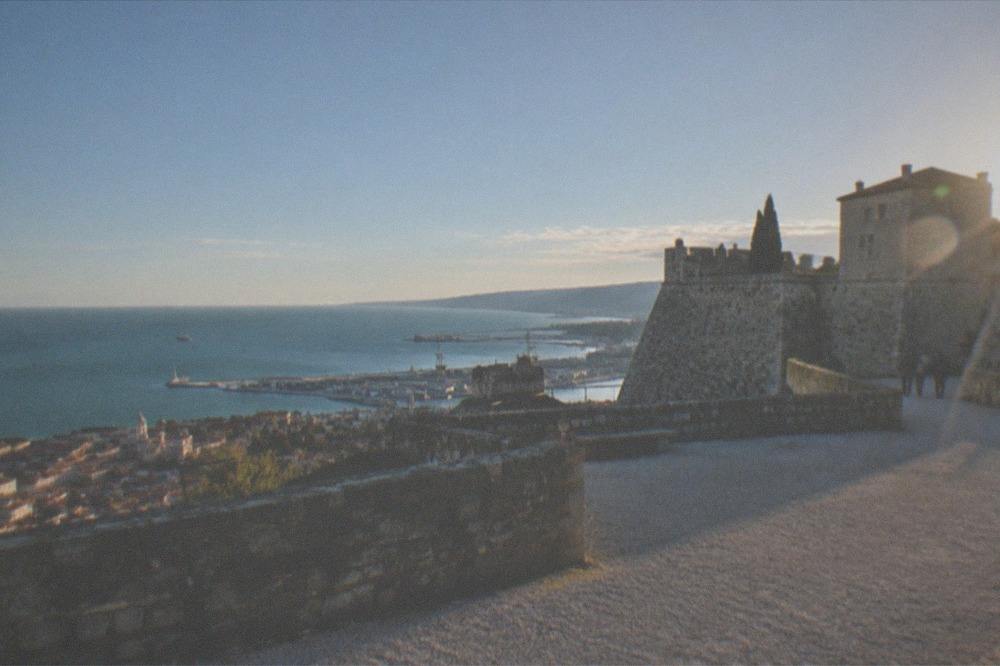 The stone walls and bastions of Castello di San Giusto above the rooftops of Trieste