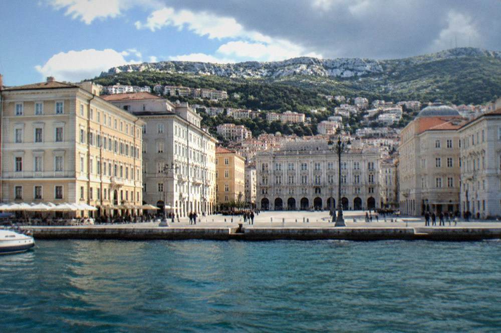 The seafront square of Trieste seen from the water with the hills behind