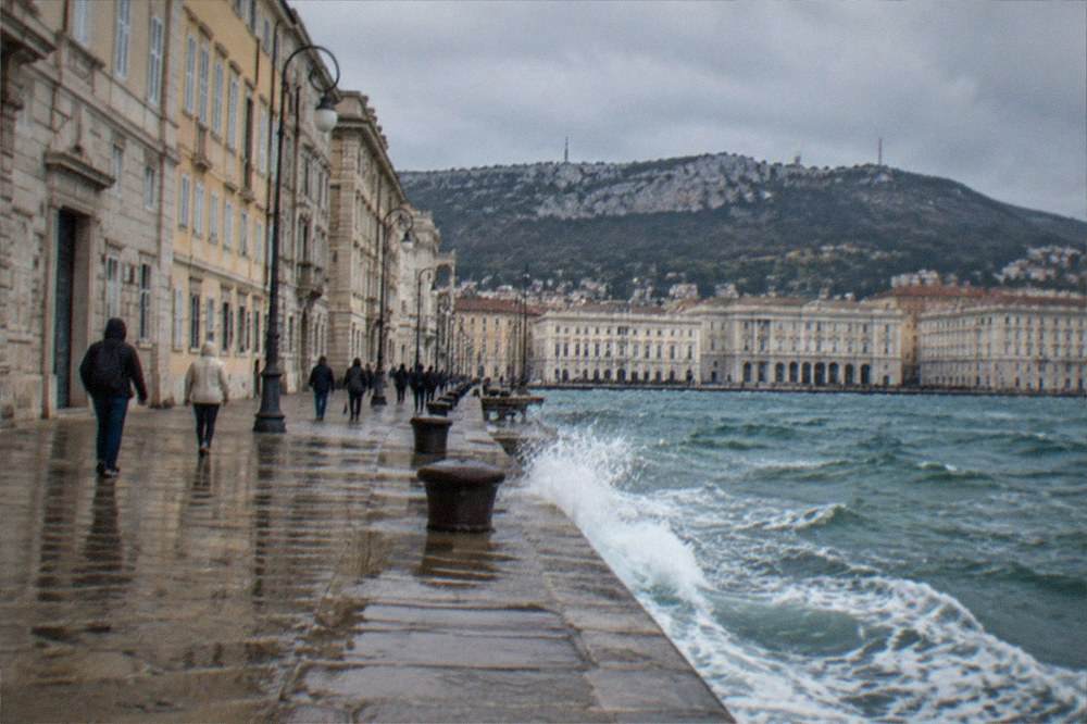 Waves breaking against the seafront on a windy autumn day in Trieste