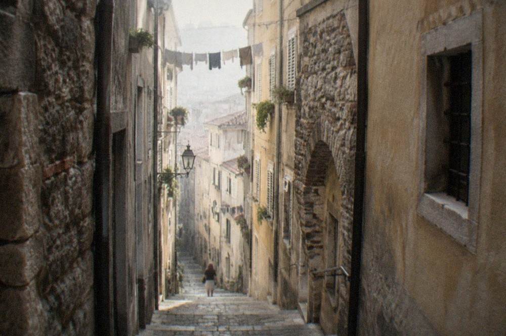 Narrow medieval lane in the Città Vecchia old town of Trieste with old stone buildings