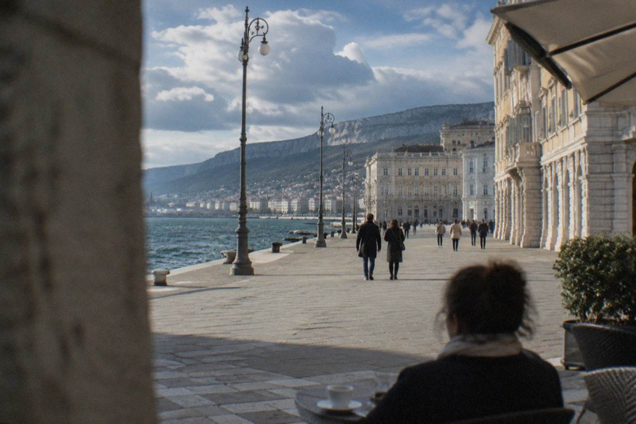The wide seafront square of Trieste with the sea on one side and ornate facades on the other
