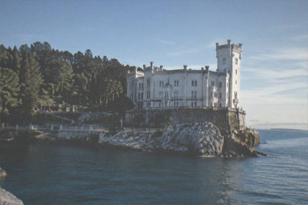 The white facade of Miramare Castle above the sea at Grignano
