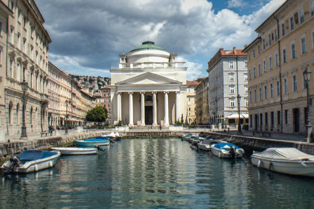 The Grand Canal in Trieste with the church of Sant'Antonio Taumaturgo at its head and small boats in the water
