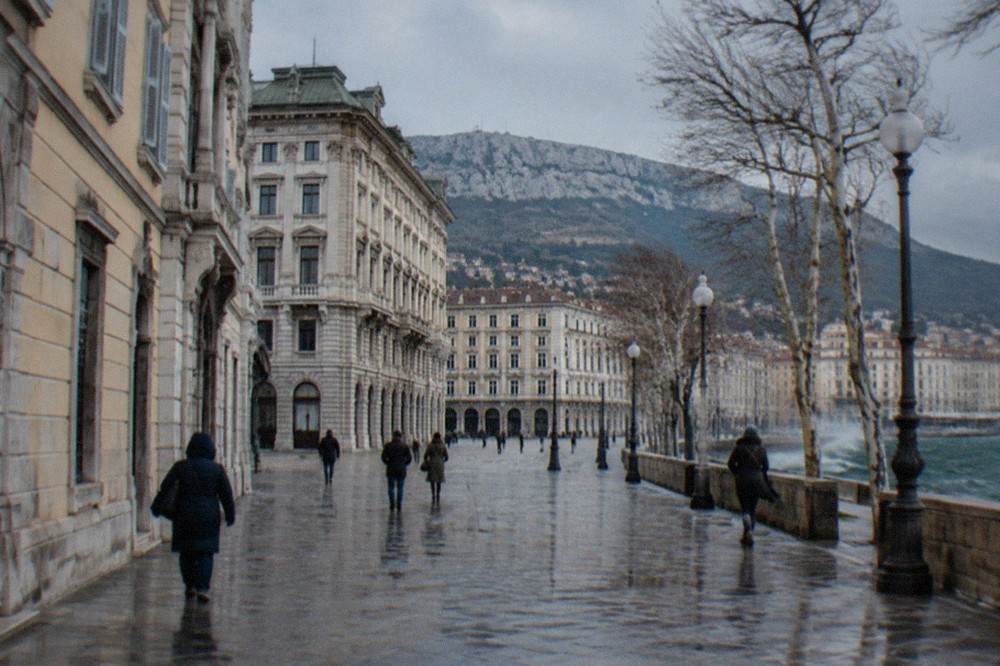 A grand Habsburg-era facade in central Trieste under a grey winter sky