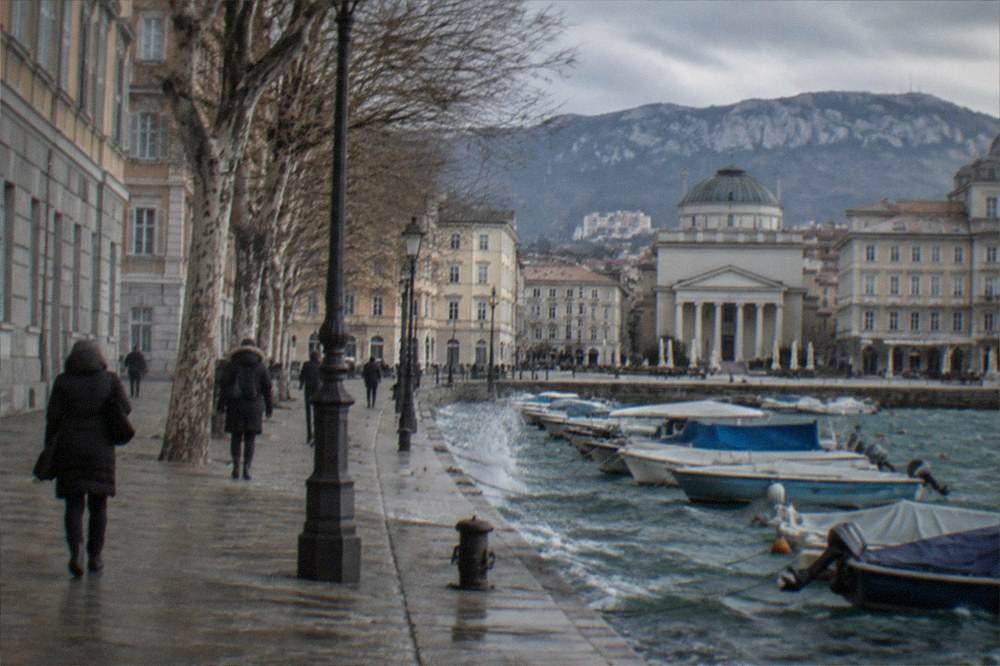 The canal and church in central Trieste on a bright cold morning with few people about
