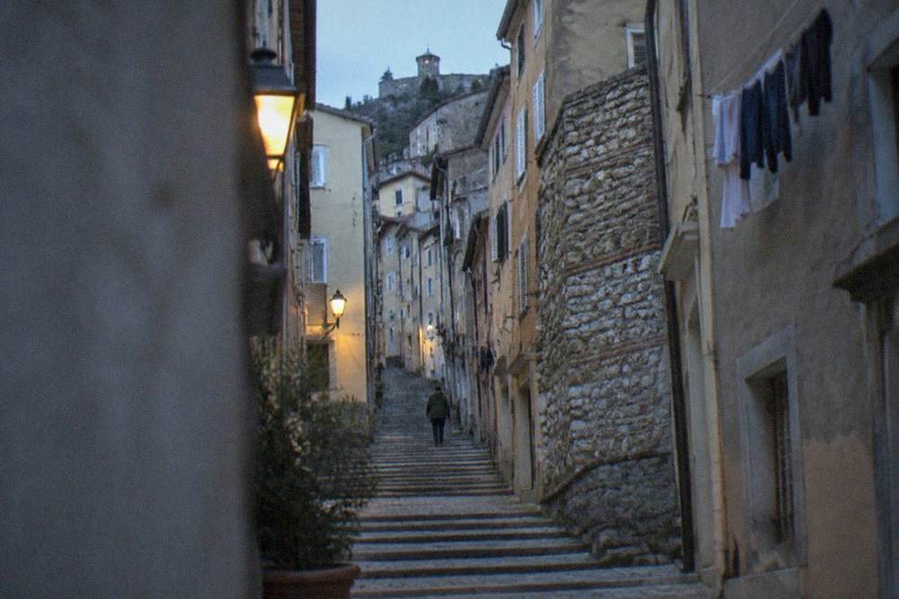 Steep stepped lanes of the Città Vecchia old town rising toward the hill of San Giusto