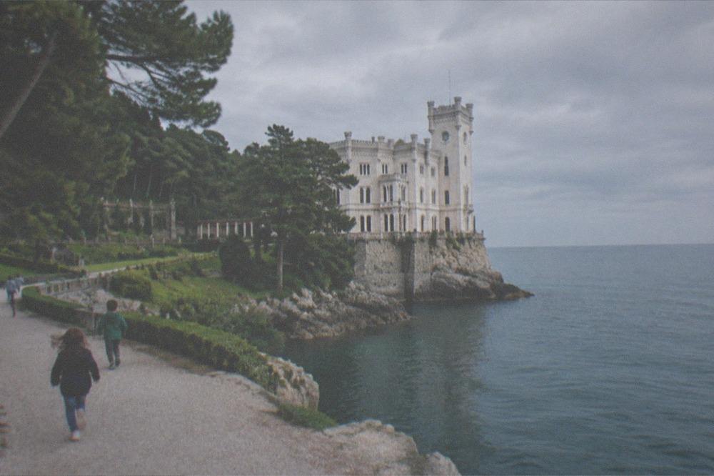 Children running on the gravel paths of the Miramare Castle park