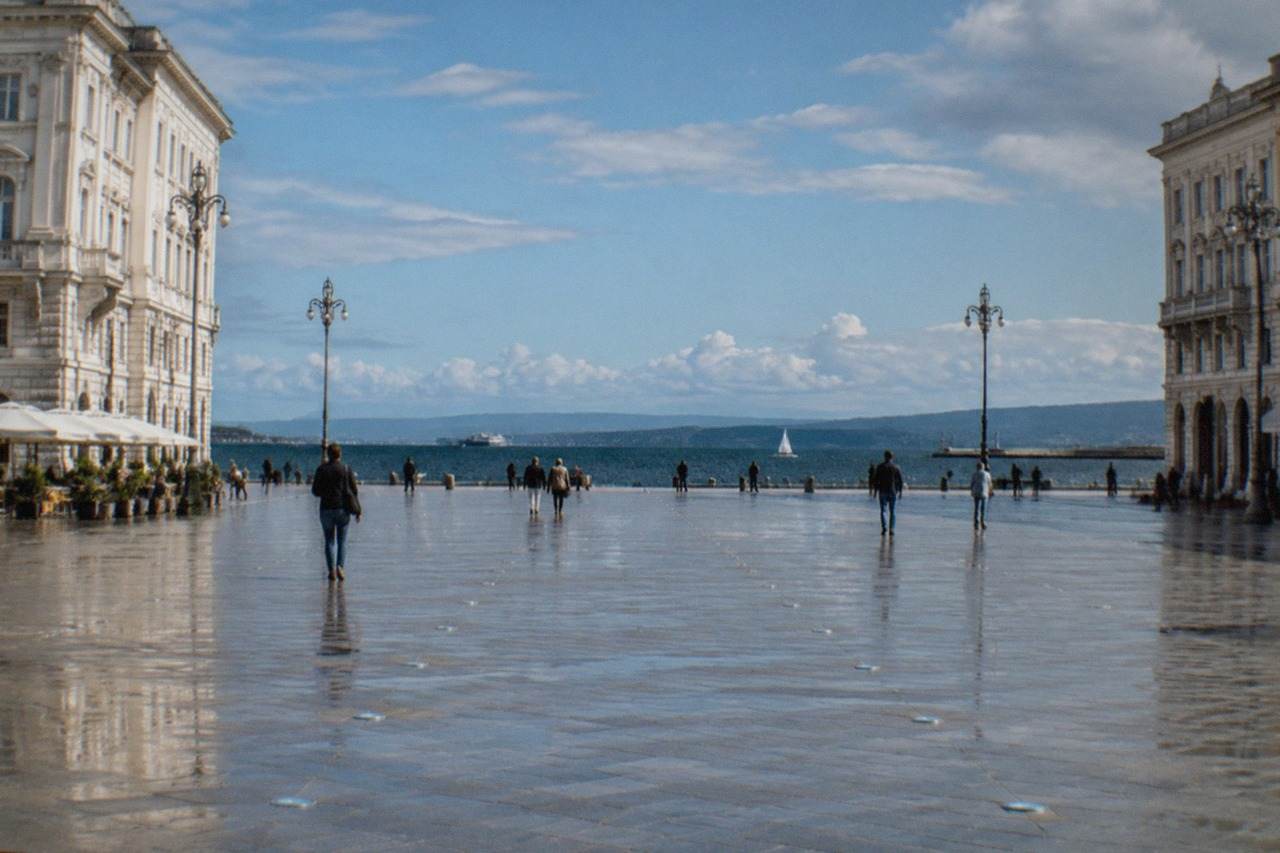 The wide open square of Piazza Unità d'Italia in Trieste facing the Adriatic Sea on a bright morning