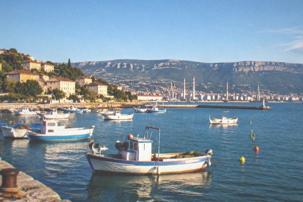 Fishing boats and a small harbour on the Muggia bay south of Trieste in late afternoon light