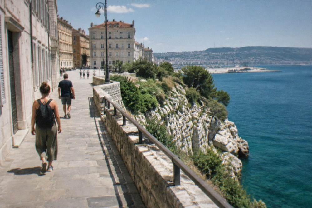 The cliff top path above the Adriatic near Trieste with white limestone rocks and the sea below